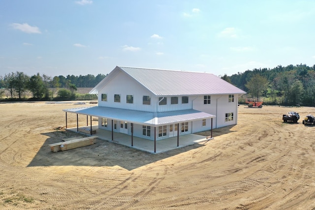 back of property featuring a patio area and metal roof
