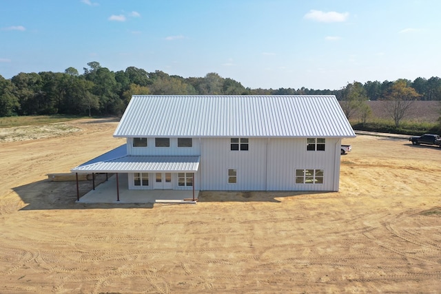 back of property featuring metal roof