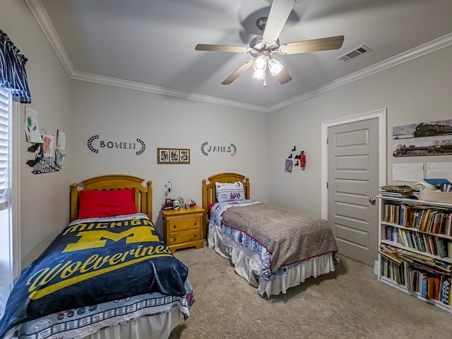 carpeted bedroom featuring visible vents, ceiling fan, and crown molding
