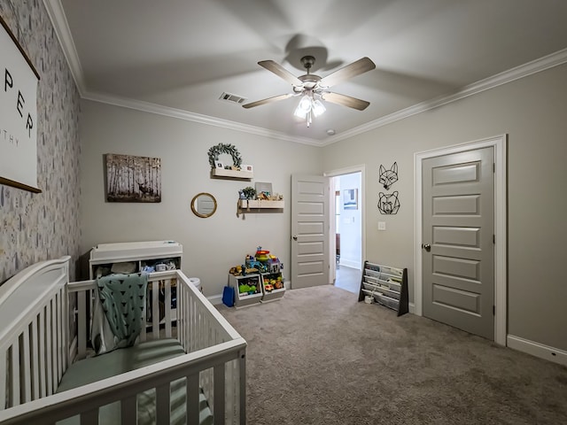 carpeted bedroom with crown molding, a ceiling fan, visible vents, and a nursery area