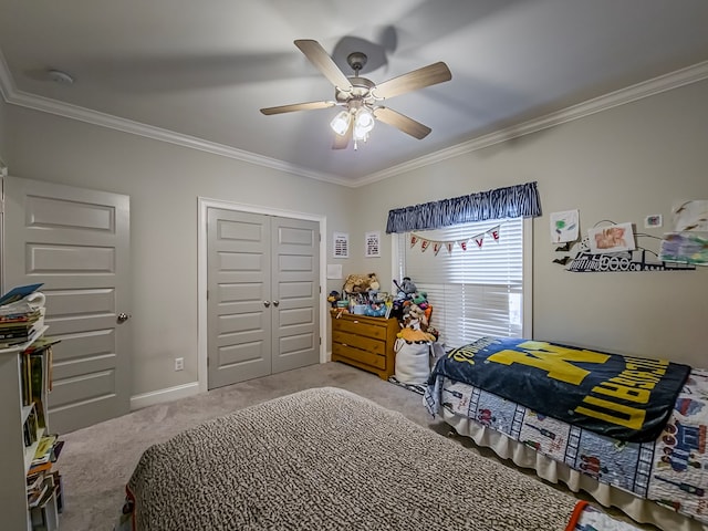 bedroom with a closet, light carpet, baseboards, a ceiling fan, and crown molding