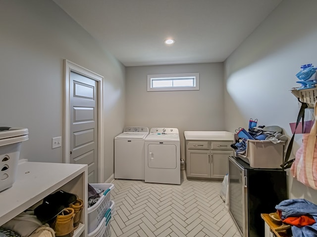 washroom featuring cabinet space and washing machine and clothes dryer