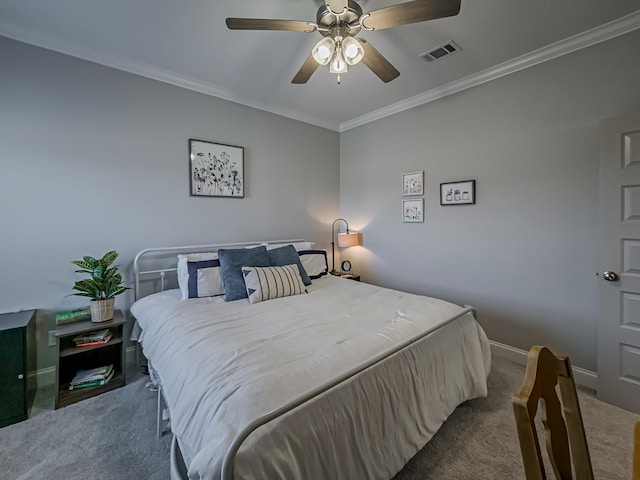 carpeted bedroom with visible vents, a ceiling fan, ornamental molding, and baseboards