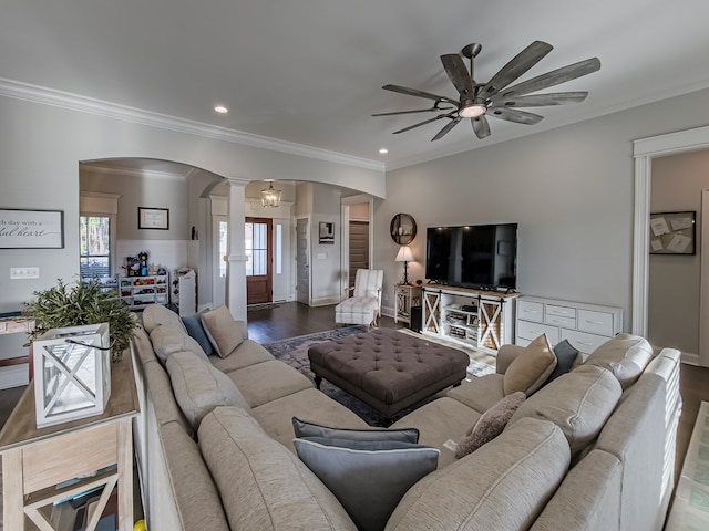 living area featuring ceiling fan, arched walkways, a wealth of natural light, ornate columns, and wood finished floors