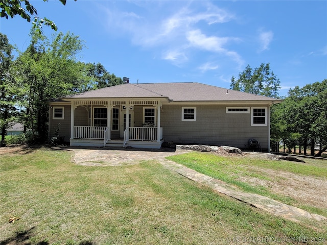 back of house featuring a porch and a yard