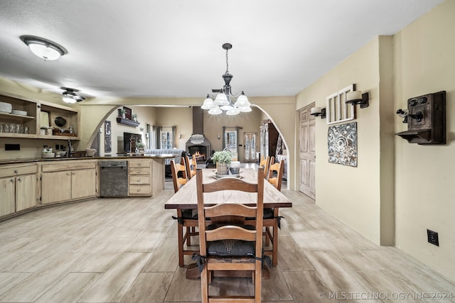 dining space featuring ceiling fan with notable chandelier and light hardwood / wood-style flooring