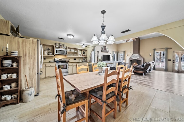 dining space with a chandelier and light wood-type flooring