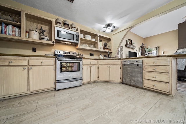 kitchen featuring light tile patterned flooring, stainless steel appliances, light brown cabinets, and ceiling fan