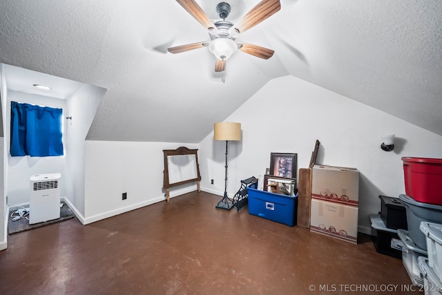 additional living space featuring a textured ceiling, lofted ceiling, and ceiling fan