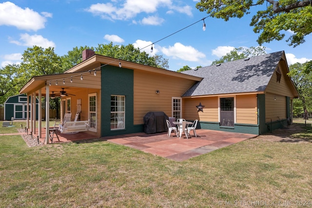 back of house featuring a patio area, ceiling fan, and a yard