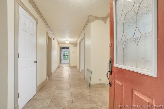 hall with crown molding, a textured ceiling, and light tile flooring