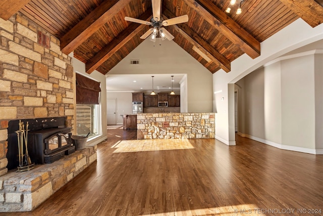 unfurnished living room with dark wood-type flooring, ceiling fan, beam ceiling, and wooden ceiling