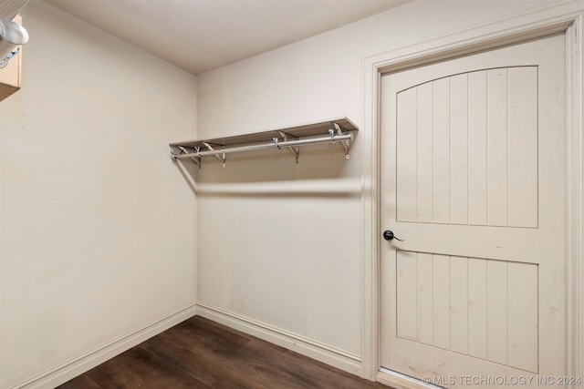 walk in closet with dark hardwood / wood-style flooring