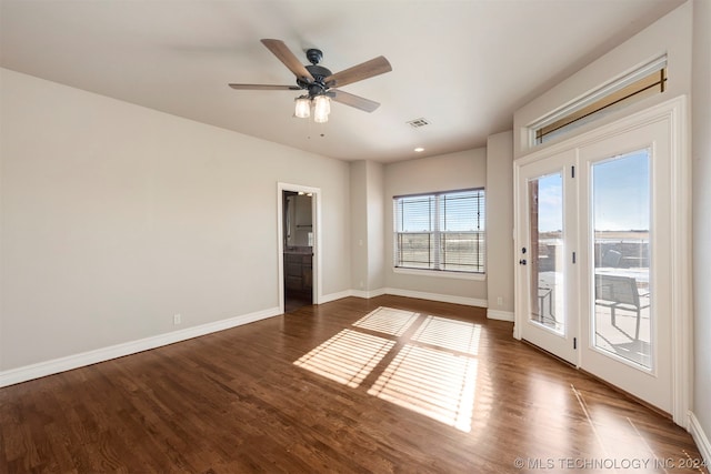 empty room with ceiling fan and dark hardwood / wood-style floors