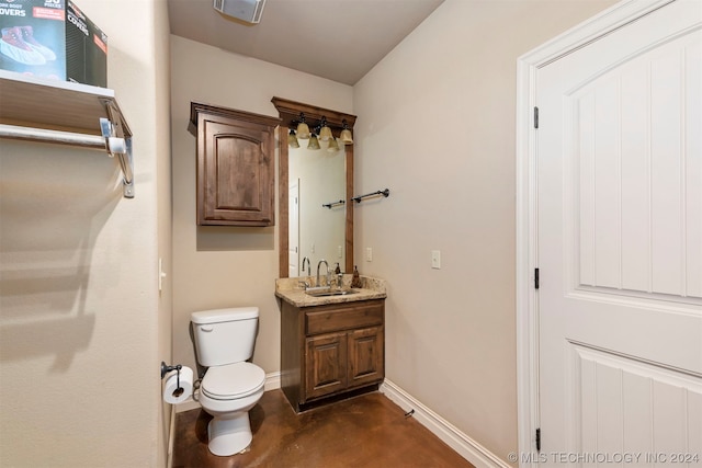 bathroom featuring vanity, toilet, and concrete flooring