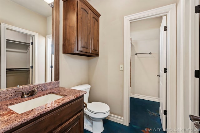 bathroom featuring toilet and vanity