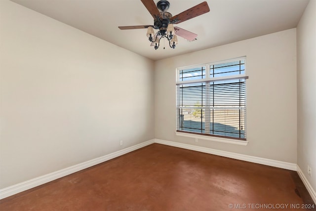 unfurnished room featuring dark carpet and ceiling fan