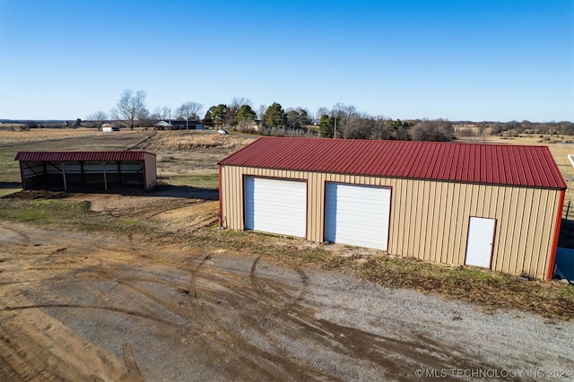 garage featuring a rural view