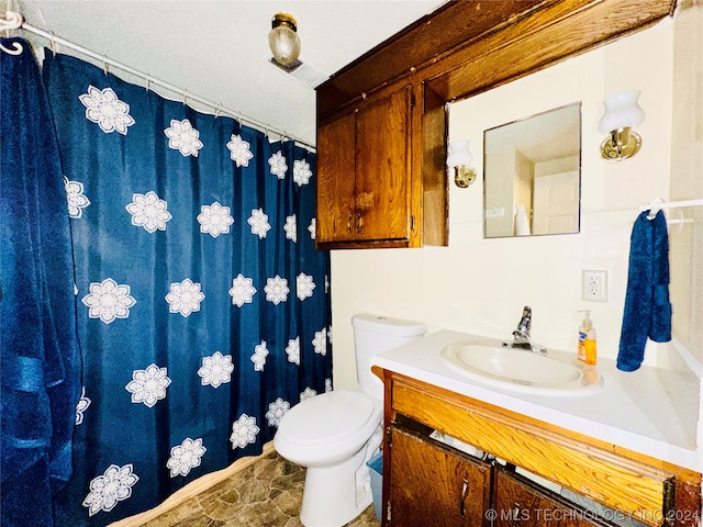 bathroom featuring oversized vanity, tile flooring, and toilet