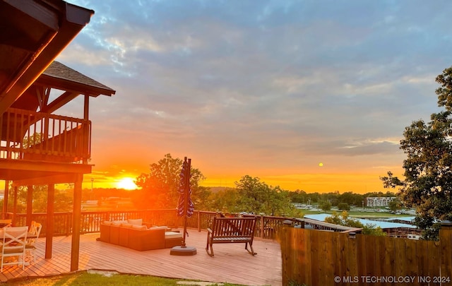 deck at dusk featuring an outdoor hangout area