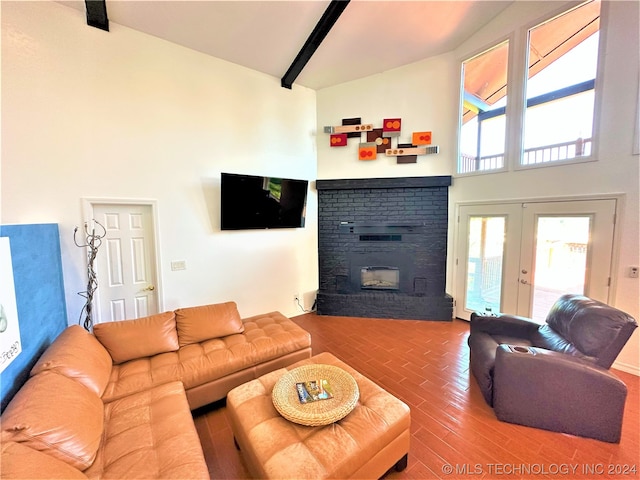 living room with high vaulted ceiling, beam ceiling, a brick fireplace, and hardwood / wood-style flooring