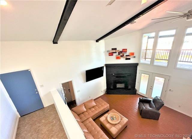 living room featuring ceiling fan, a brick fireplace, and vaulted ceiling with beams