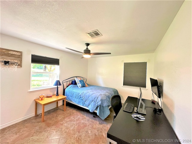 bedroom featuring a textured ceiling and ceiling fan