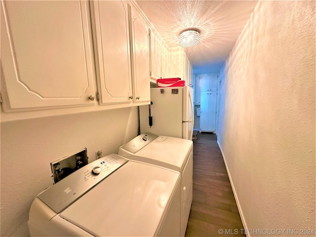 laundry area featuring dark hardwood / wood-style floors, cabinets, and separate washer and dryer