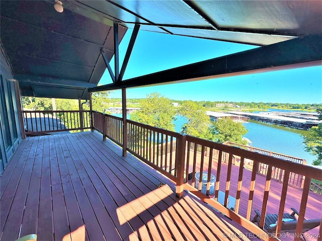 wooden terrace featuring a water view