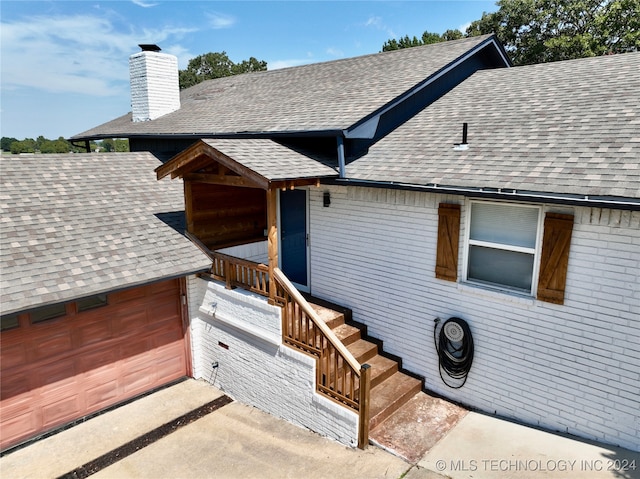 doorway to property with a garage