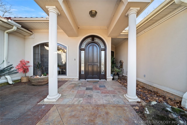 view of exterior entry featuring french doors and a patio area