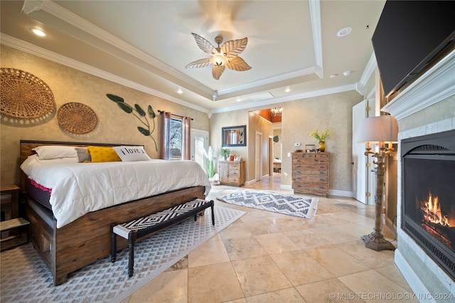 bedroom with ceiling fan, ornamental molding, light tile flooring, and a raised ceiling