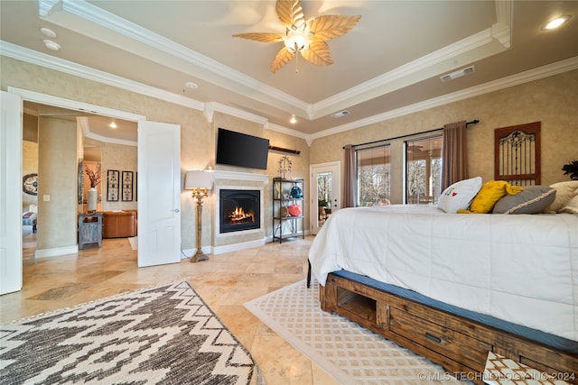 tiled bedroom with crown molding, ceiling fan, and a raised ceiling