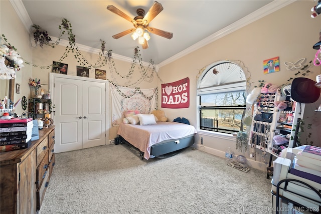 carpeted bedroom featuring ceiling fan and ornamental molding