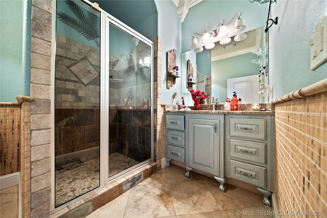 bathroom featuring crown molding, an enclosed shower, vanity, and tile flooring