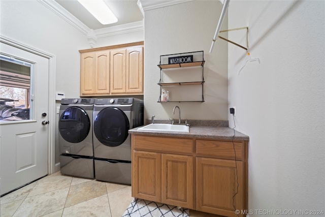 clothes washing area featuring sink, crown molding, light tile flooring, cabinets, and separate washer and dryer