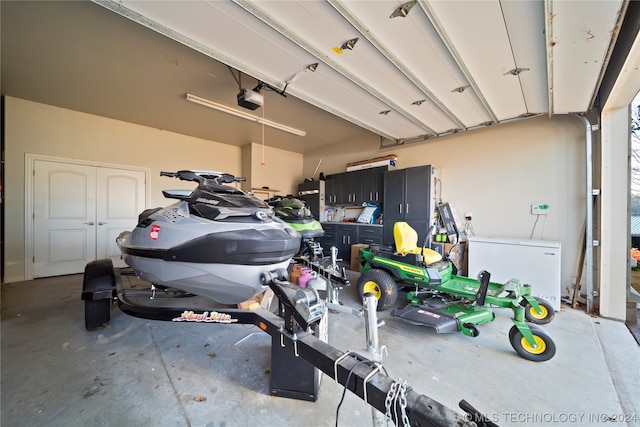 garage featuring refrigerator and a garage door opener