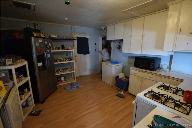 kitchen with stainless steel refrigerator with ice dispenser, white gas range, light wood-type flooring, and white cabinetry