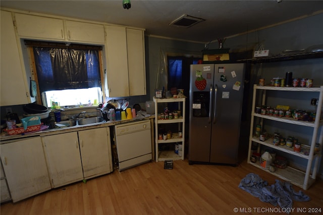 kitchen with white dishwasher, stainless steel refrigerator with ice dispenser, sink, and light hardwood / wood-style flooring