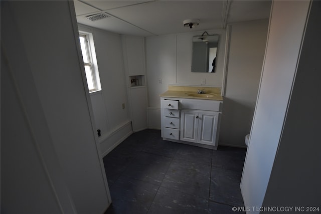 bathroom with toilet, oversized vanity, and tile flooring