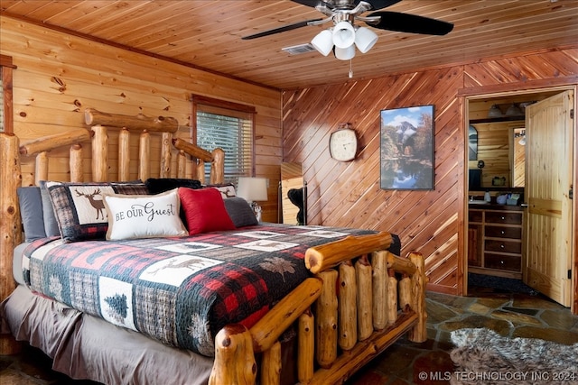 tiled bedroom featuring wooden walls, ceiling fan, and wood ceiling