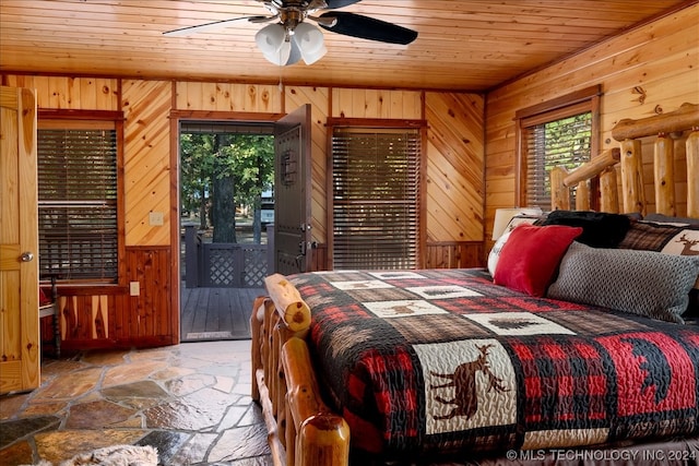 bedroom featuring access to exterior, wooden ceiling, ceiling fan, wooden walls, and tile flooring