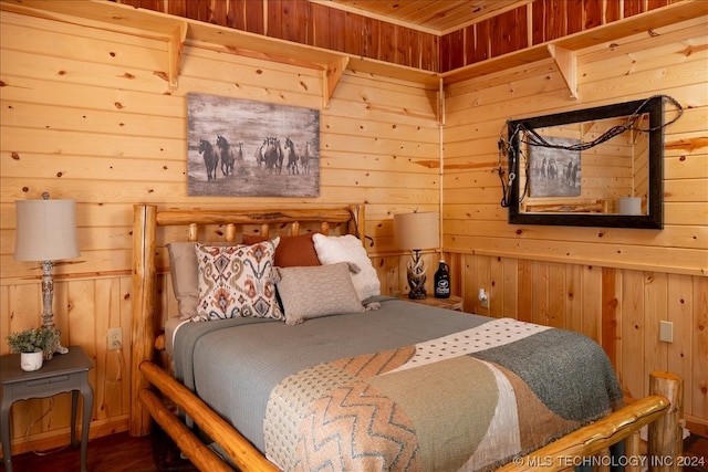 bedroom featuring wooden walls