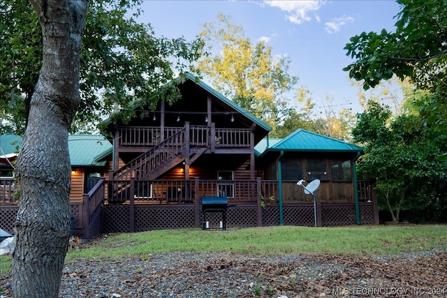 back of house featuring a wooden deck