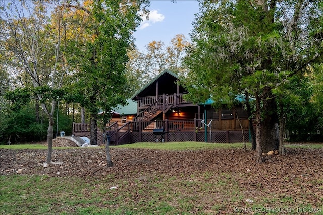 rear view of house featuring a deck