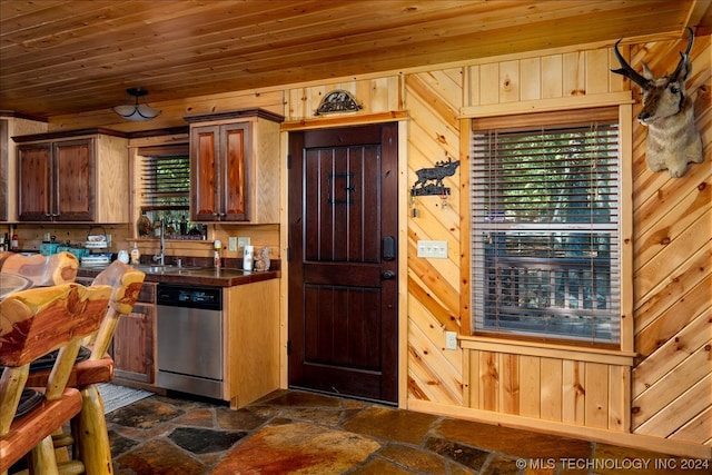 kitchen with wooden walls, wooden ceiling, dark tile floors, and dishwasher