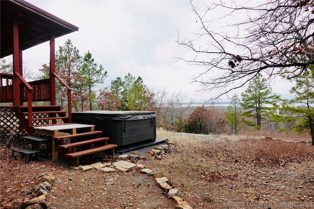 view of yard featuring a hot tub and a wooden deck