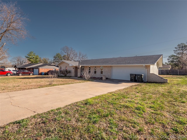 ranch-style home with a garage and a front lawn