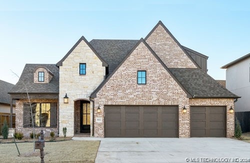 french provincial home featuring a garage