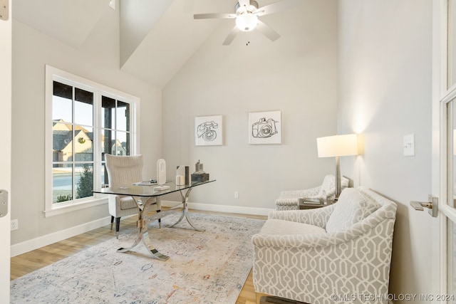 office featuring ceiling fan, light wood-type flooring, and high vaulted ceiling